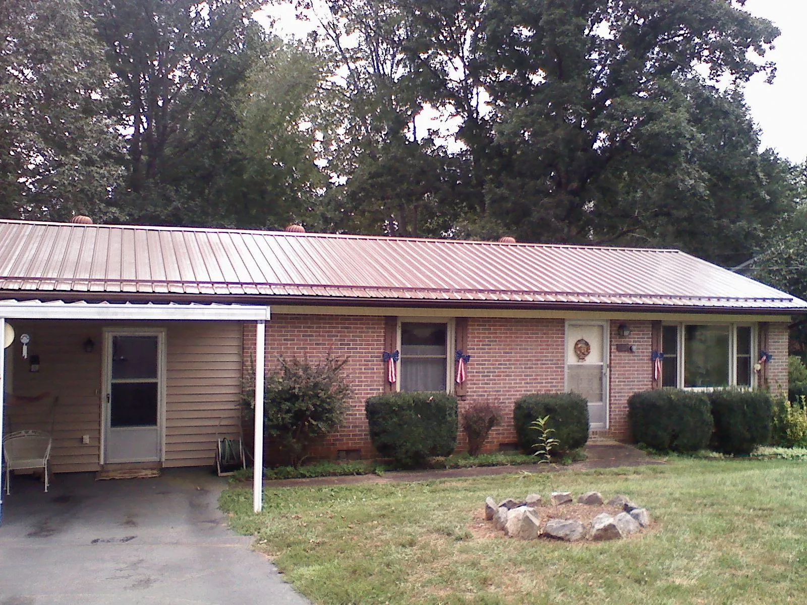 Bronze metal roof and carport on a brick ranch home — Roof Repair work by our crew in Valley