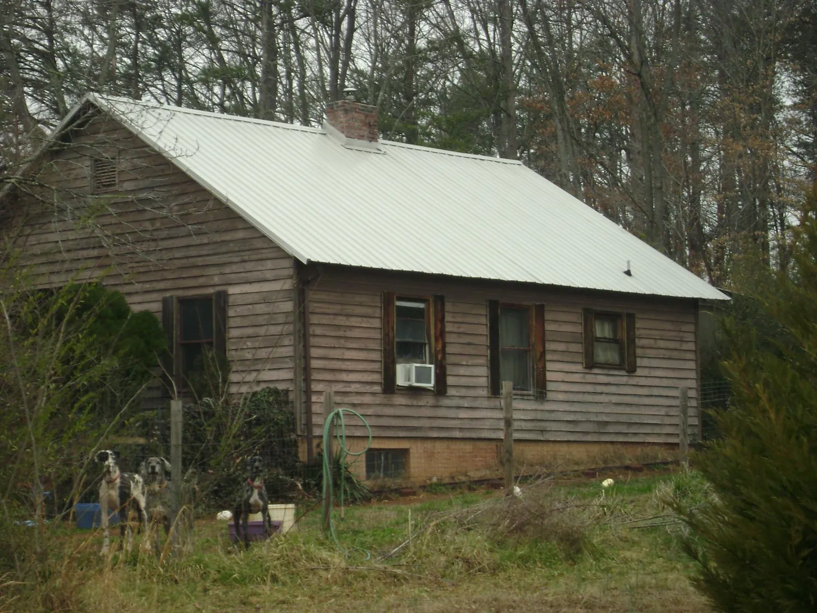 White metal roof on an old wood sided farmhouse, from a Metal Roof Installation job in Valley